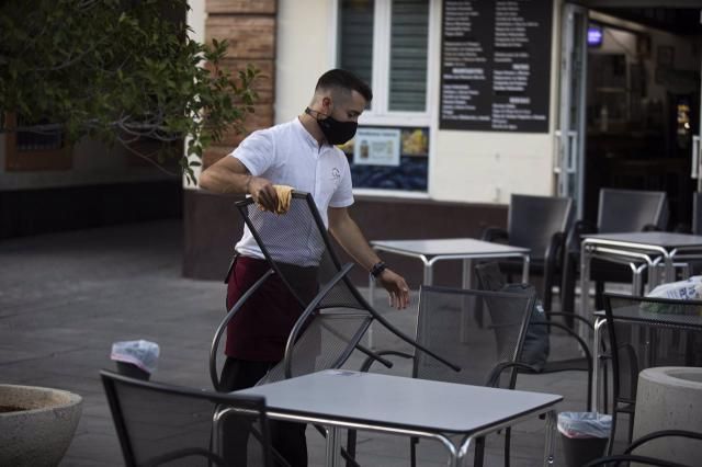 Un camarero recoge el mobiliario de la terraza de un bar | Imagen de archivo | María José López | Europa Press